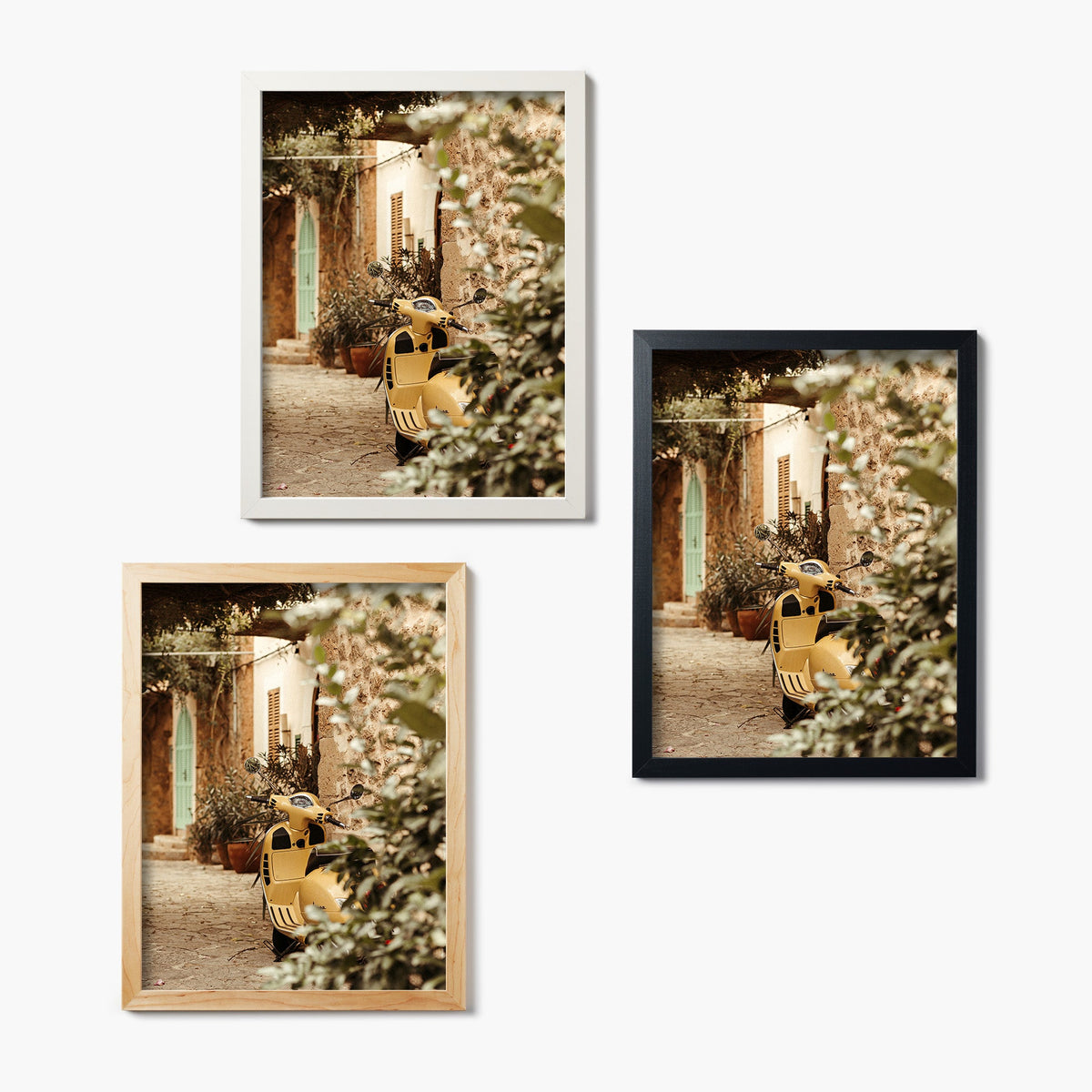 Set of three framed glass prints featuring a yellow scooter in an outdoor setting with flowers and a building.