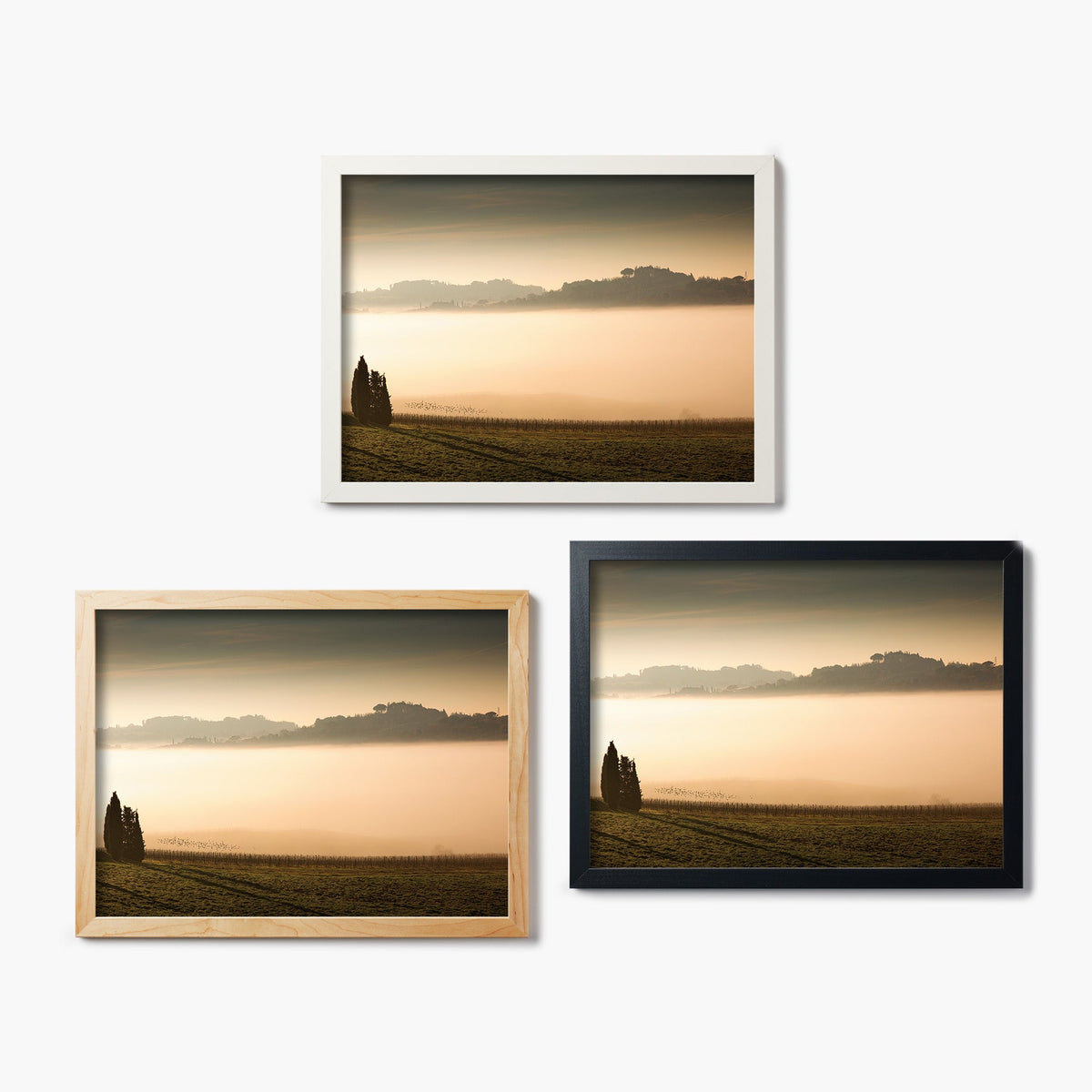 Three framed glass prints of a sunset over a vineyard with silhouetted trees.