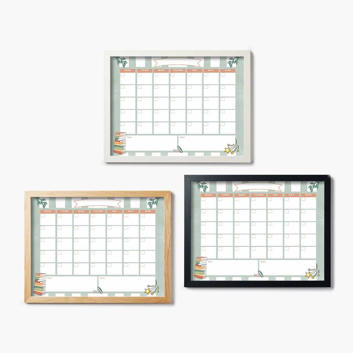 Glass prints of three wall-mounted calendars with different frame colors on a white background