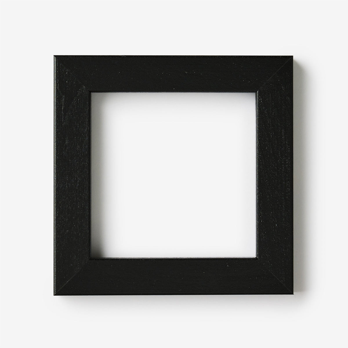 A small square black wood frame on a white background